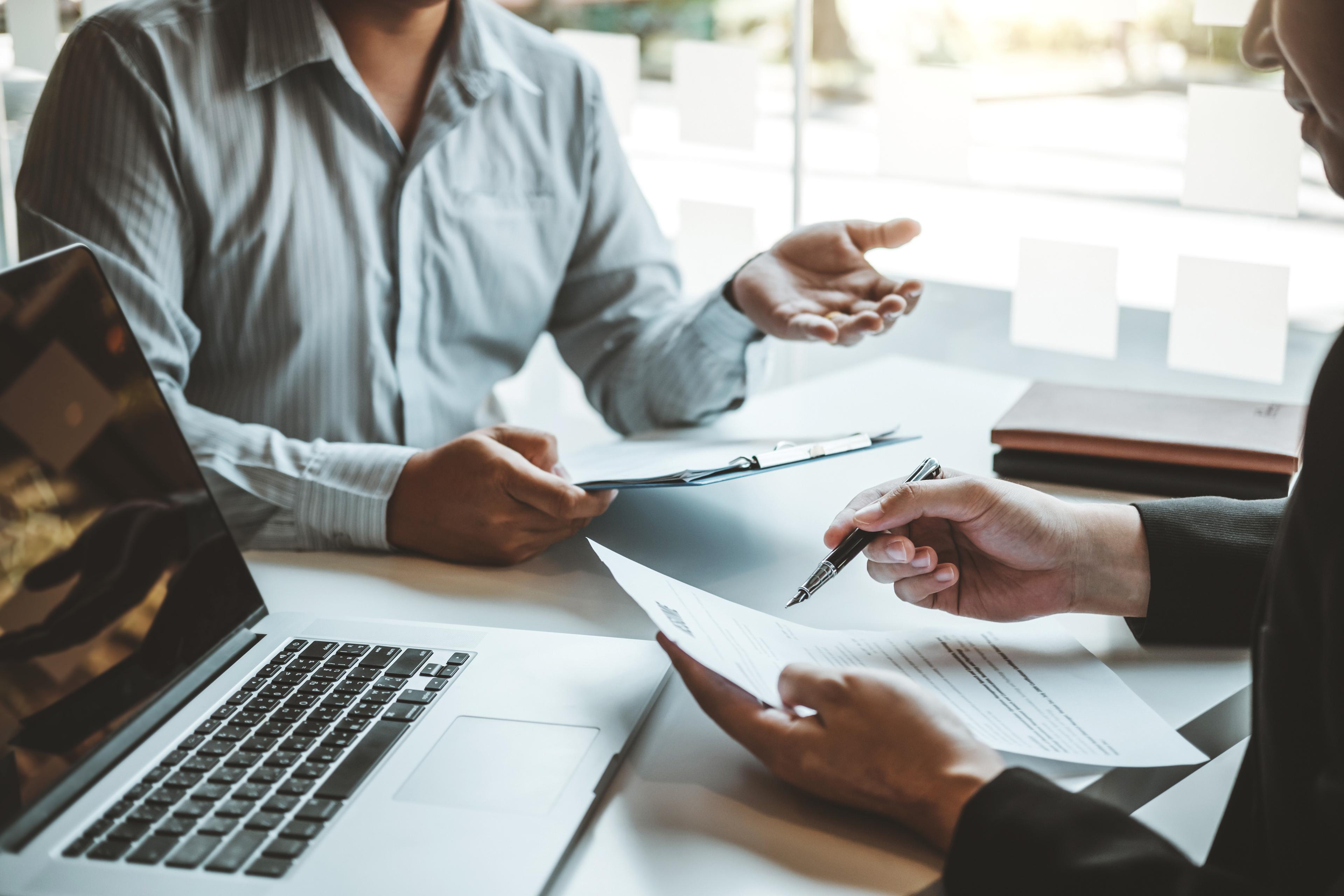 A hiring manager reviewing job applications at a desk, illustrating how AI is changing candidate screening in New Zealand.